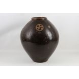 A late 19th / early 20th Century large terracotta pot in dark brown glaze.