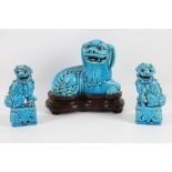A Chinese Republic period pottery model of a Fu lion on hardwood stand, together with a pair of