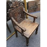 A Chinese 19th Century hardwood armchair, the back carved with a dragon.