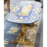 An Italian faux Pietra Dura painted table, on elaborate baroque style gilded base with cherubs and