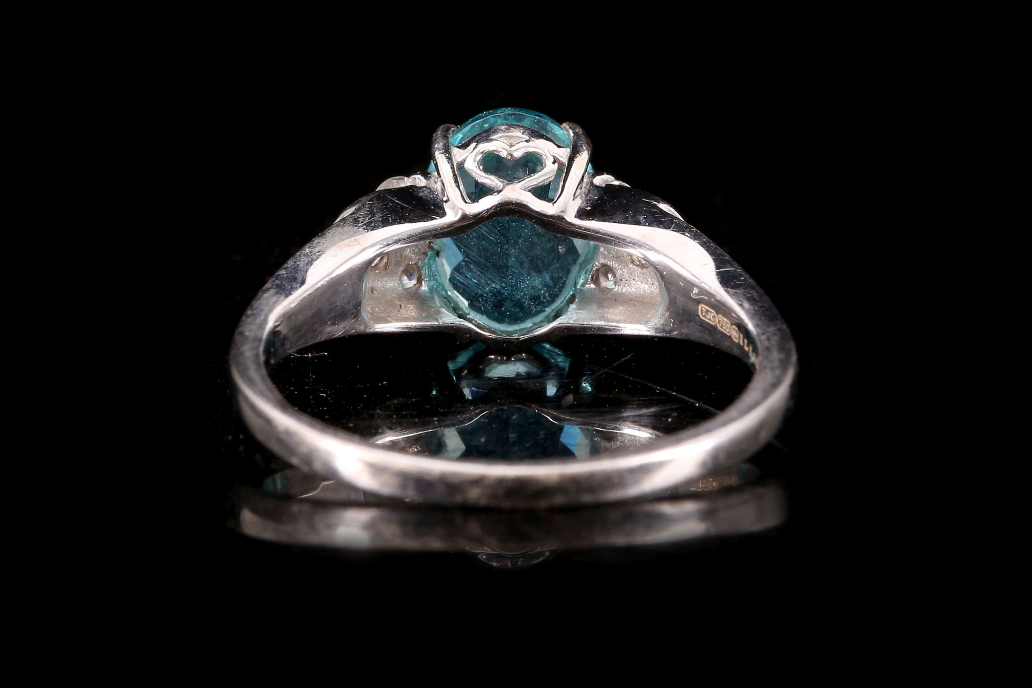 An 18 carat white gold, diamond and blue apatite ring, set oval cut apatite flanked by six round cut - Image 2 of 2