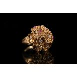 A yellow gold, diamond and ruby dress ring c.1960, designed as a multi flower cluster, each flower