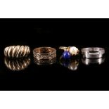 A collection of four rings 1st: Of reeded bombè design, 2nd: Of indented geometric design, 3rd: