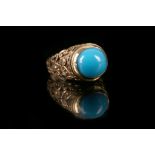 A turquoise dress ring The collet-set oval turquoise, to a pierced gallery, ring size I½, total