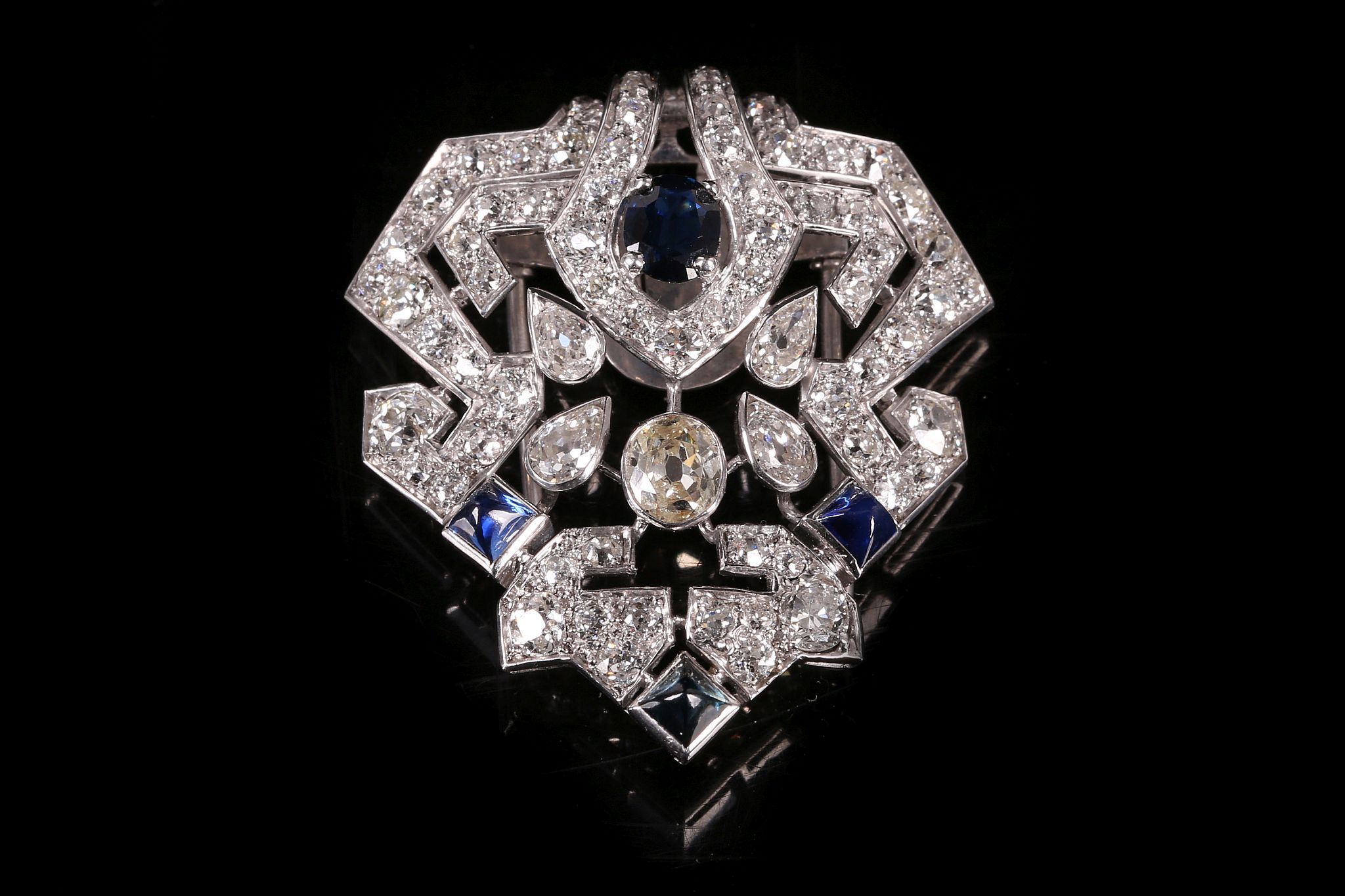 An Art Deco sapphire and diamond clip brooch, circa 1925 Of geometric form, set throughout with