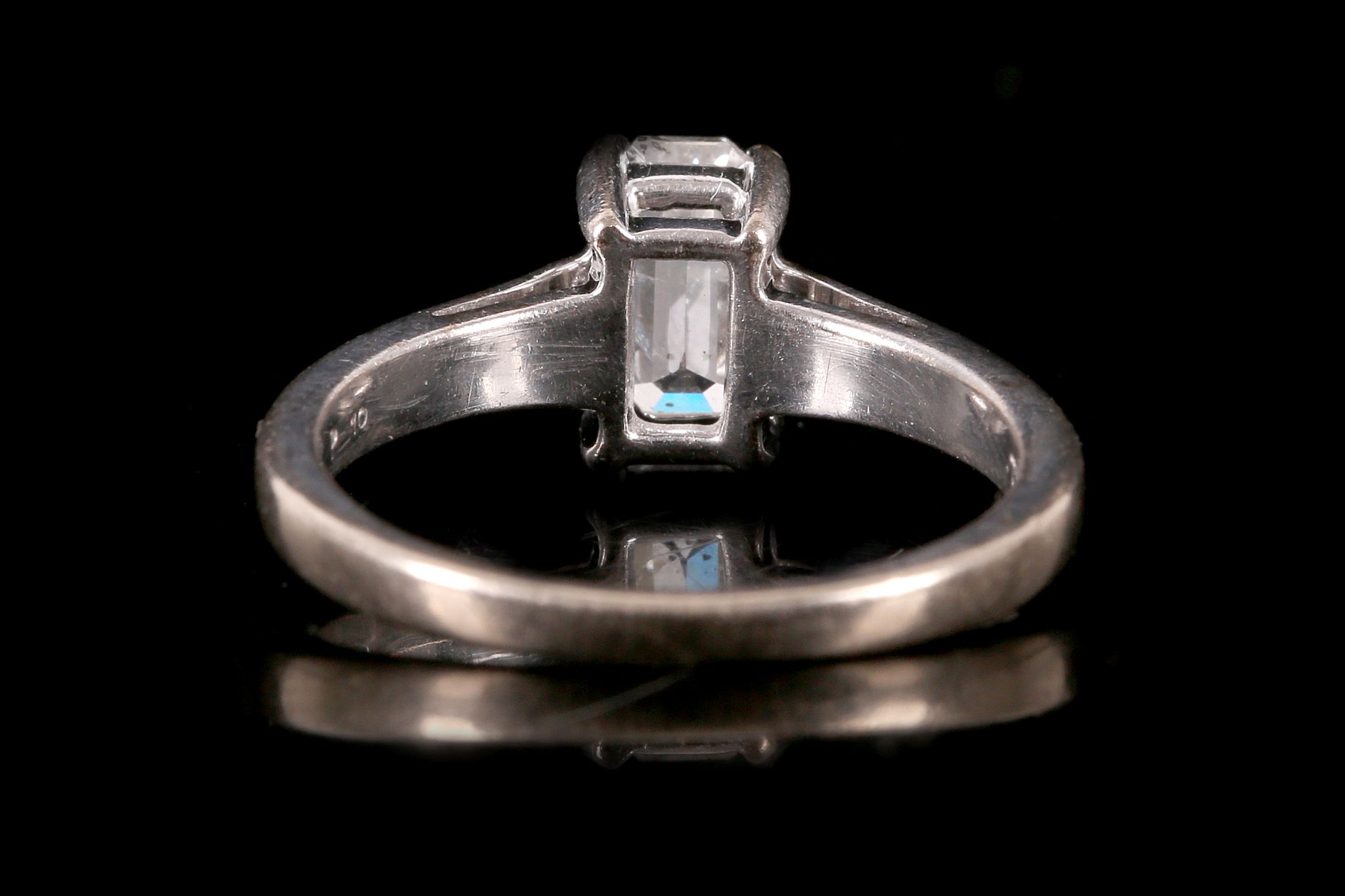 A diamond single-stone ring The cut-cornered step-cut diamond, in a four-claw setting, to an 18 - Image 2 of 2