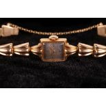 LADIES 'CYMA' BRACELET WATCH. A ladies c.1940's 18ct gold 'Cyma' bracelet watch, with silvered dial,