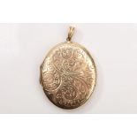 A locket pendant The oval locket decorated with scrolling motifs, opening to reveal two glazed