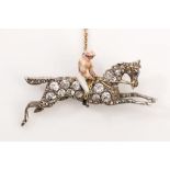 A diamond jockey brooch The pink and yellow enamel jockey astride the old brilliant and rose-cut