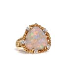 An opal and diamond dress ring, by John Donald, 1976 The triangular opal within an 18 carat yellow