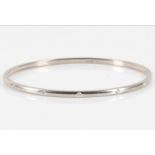 A white gold and diamond bangle, by Theo Fennell The thin brushed 18 carat white gold bangle set