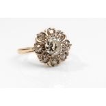 A diamond cluster ring The old brilliant-cut diamond, within a surround of similarly-cut diamonds,