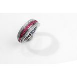 A ruby, sapphire and diamond flip ring Centrally channel-set with French-cut rubies and sapphires,