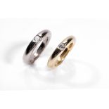 A pair of diamond-set rings, by Cartier Bi-coloured, each set with a brilliant-cut diamond, to a