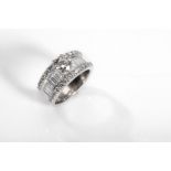 A diamond dress ring Set with a brilliant-cut diamond, to a band of baguette and brilliant-cut