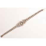 A late 19th century floral diamond bracelet The articulated line of stylized leaves set with