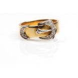 A gold and diamond buckle ring, 1989 The 18 carat yellow gold band, featuring a brilliant-cut