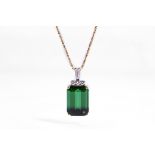 A green tourmaline and diamond pendant necklace The step-cut green tourmaline, in a four-claw