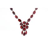 A garnet pendant necklace, circa 1890 The oval-cut garnets, centrally featuring an oval, marquise-