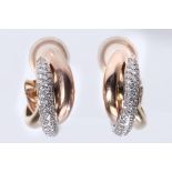 A pair of diamond-set 'Trinity' hoop earclips, by Cartier The tri-coloured hoops, one pave-set
