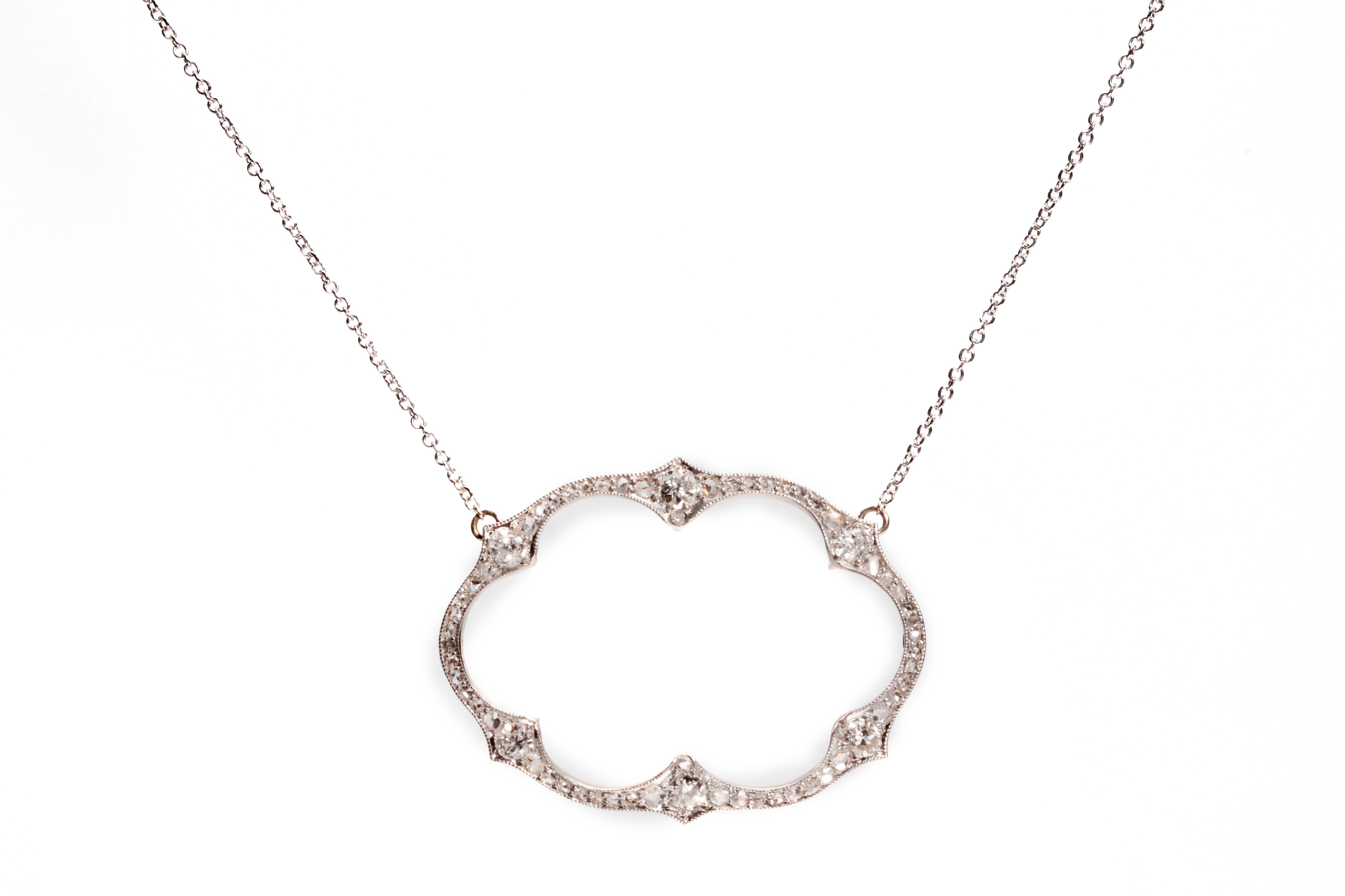 A diamond pendant necklace The openwork oval pendant set with brilliant and rose-cut diamonds,