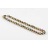 A WMF bead necklace The single-strand of 6.9-7.6mm iridescent beads of green hue, length 41.7cm