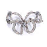 A diamond bow brooch, circa 1905 The ribbon set with three larger millegrain collet-set old