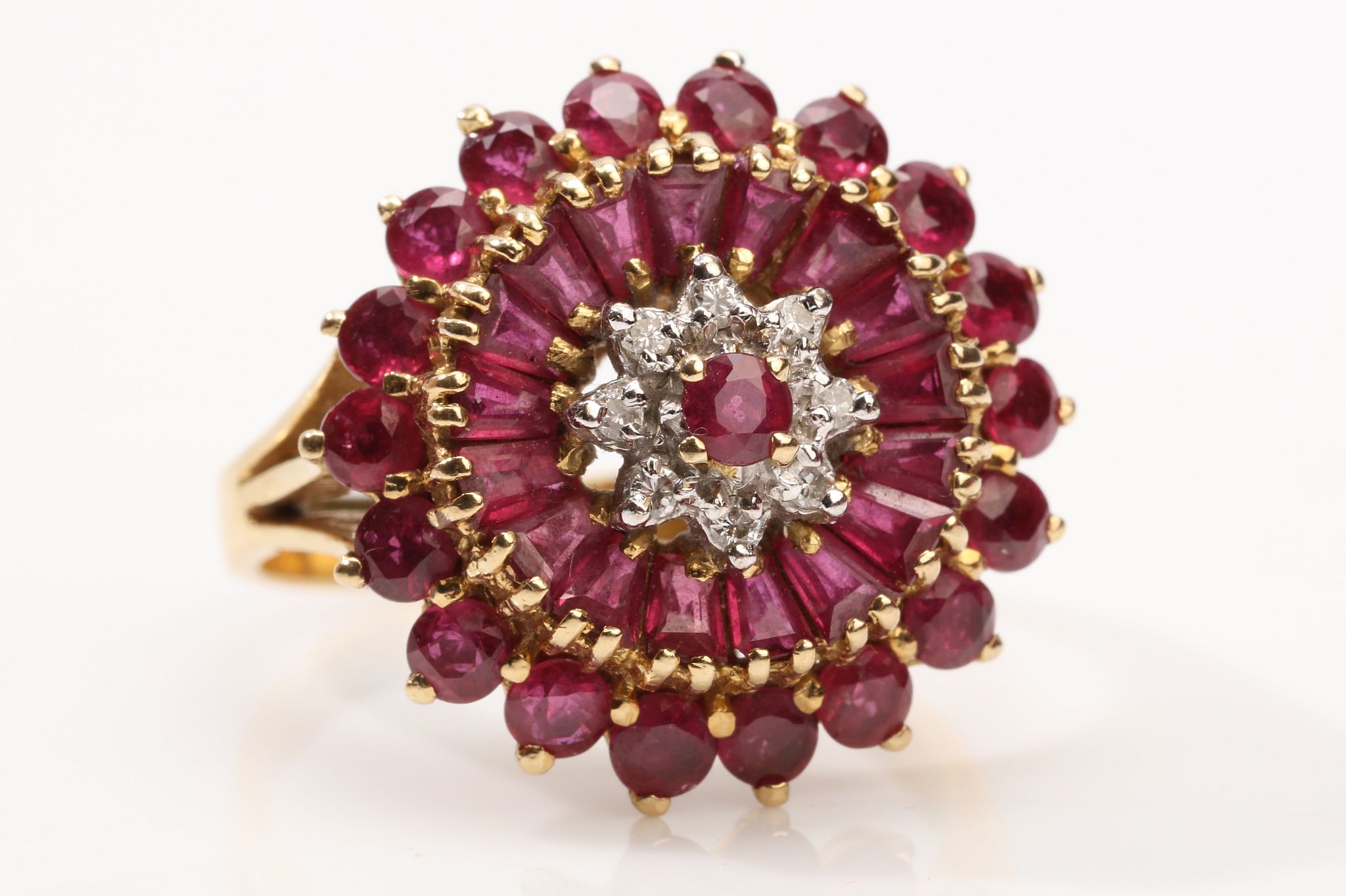 A garnet and moissanite cluster ring Set with baguette and circular-cut garnets centrally set with a