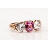 A ruby and diamond three-stone ring The oval-cut ruby, between old brilliant-cut diamonds,