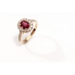 A ruby and diamond cluster ring The oval-cut ruby, weighing 1.35 carats, within a surround of