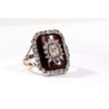 A diamond dress ring, early 19th century The slightly curved rectangular maroon plaque, centrally