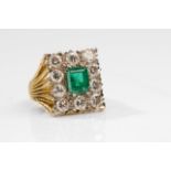 An emerald and diamond cluster ring, by David Thomas, 1999 The step-cut emerald within a square