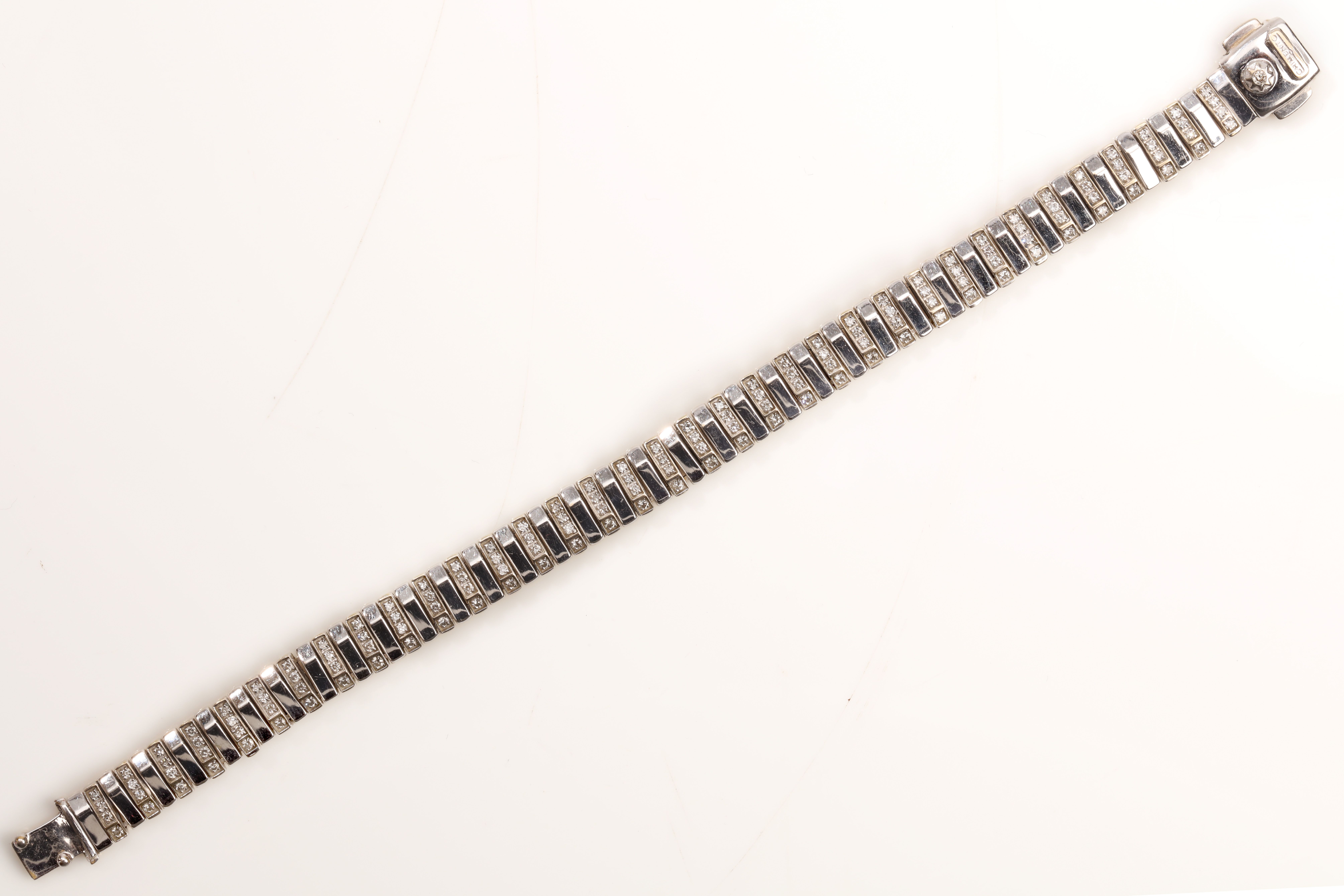 A diamond-set bracelet, by Chimento Composed of alternating bi-coloured bar links, accented by
