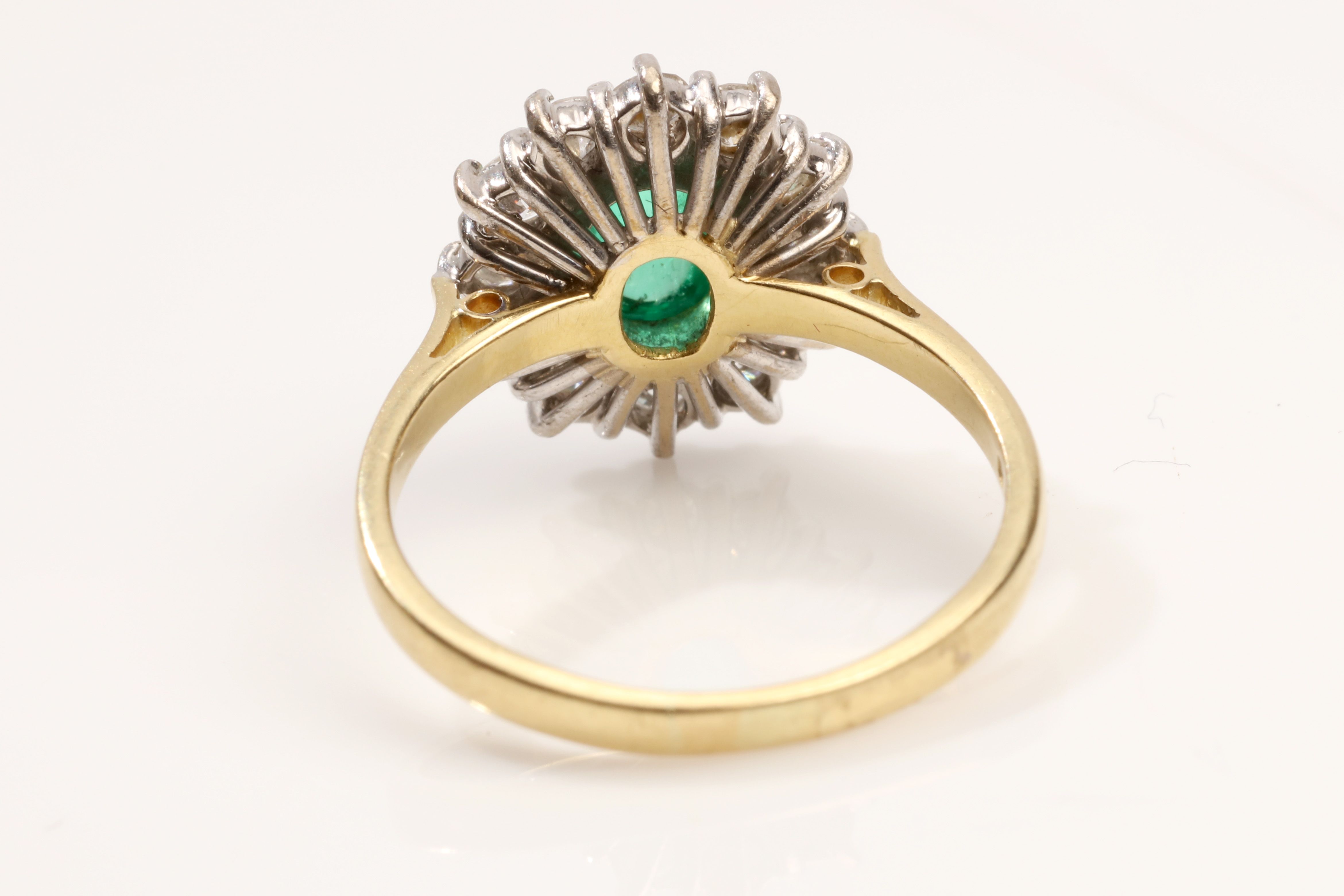 An emerald and diamond cluster ring, 1989 The collet-set oval-cut cabochon emerald, within a - Image 3 of 3