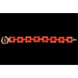 An openlink coral bracelet, with an onyx and coral clasp, length 19.2cm. Clasp stamped 9ct.