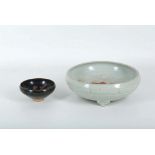 A Chinese Ming Dynasty period pottery, light grey lustre glazed bowl, raised on three feet, and a