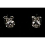 A  pair of white metal coronet claw set diamond stud earrings, each stone being approx. 30cts.