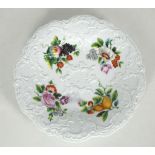 A late 19th Century Meissen hard paste porcelain charger, painted in the centre with exotic fruits