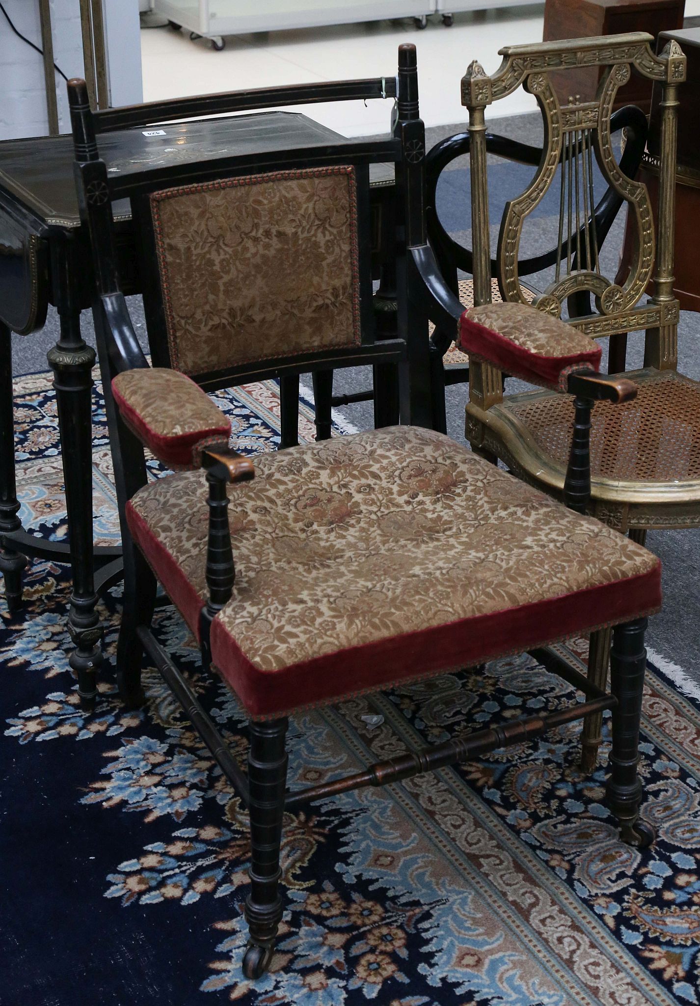 A late 19th Century ebonised armchair as designed for Dromore Castle, in the manner of Edward