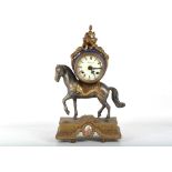 A 20th Century French Empire style gilded metal mantel clock, supported by a horse, having Roman