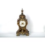 A rococo style 20th Century brass mantle clock, 48cm high.