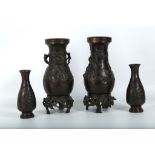 A pair of Japanese bronzes vases on signed stands, sold with a pair of small Japanese bronze