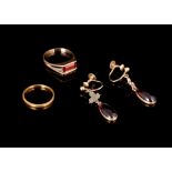 A pair of garnet and gold pendant earrings, a gold band ring and a garnet ring.