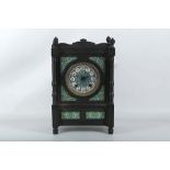 An ebonised aesthetic period mantel clock with brightly painted panels.