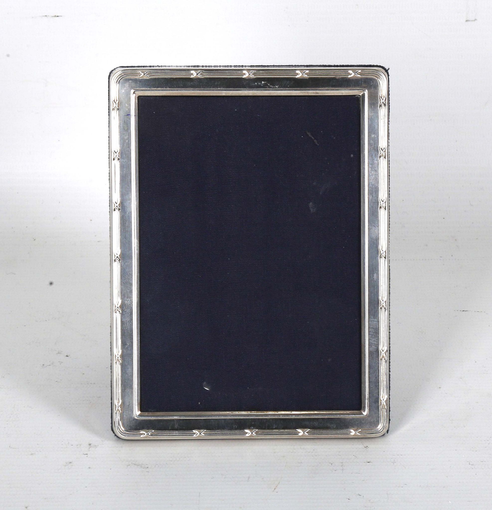 A modern Sheffield hallmarked silver photograph frame, having plain border, blue velvet back and