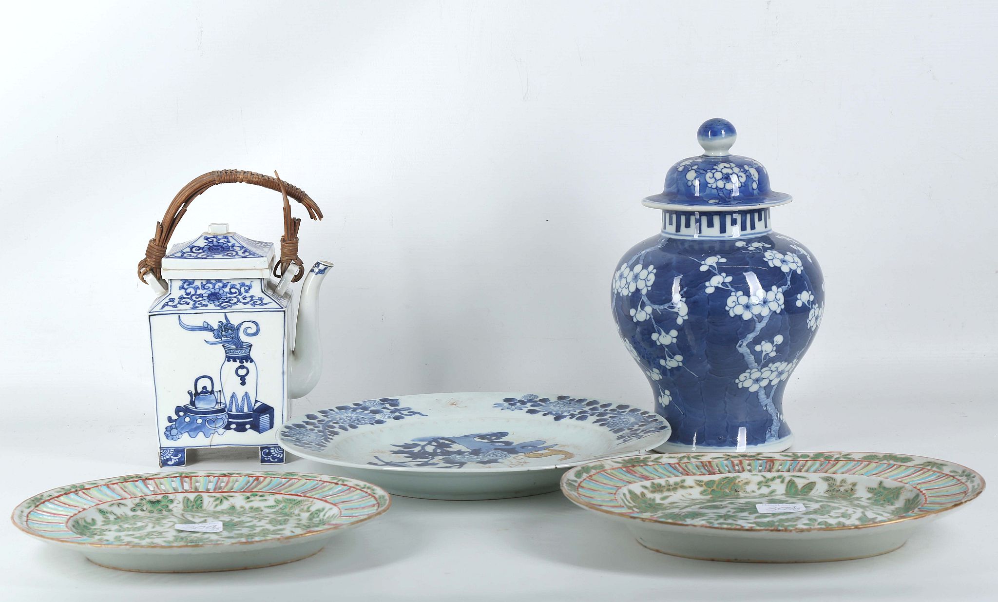 An 18th Century Chinese porcelain charger, painted in blue and white with flora and fauna, Kangxi