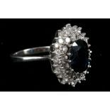 A sapphire and diamond cluster ring, the oval shaped mixed cut sapphire within a two row brilliant