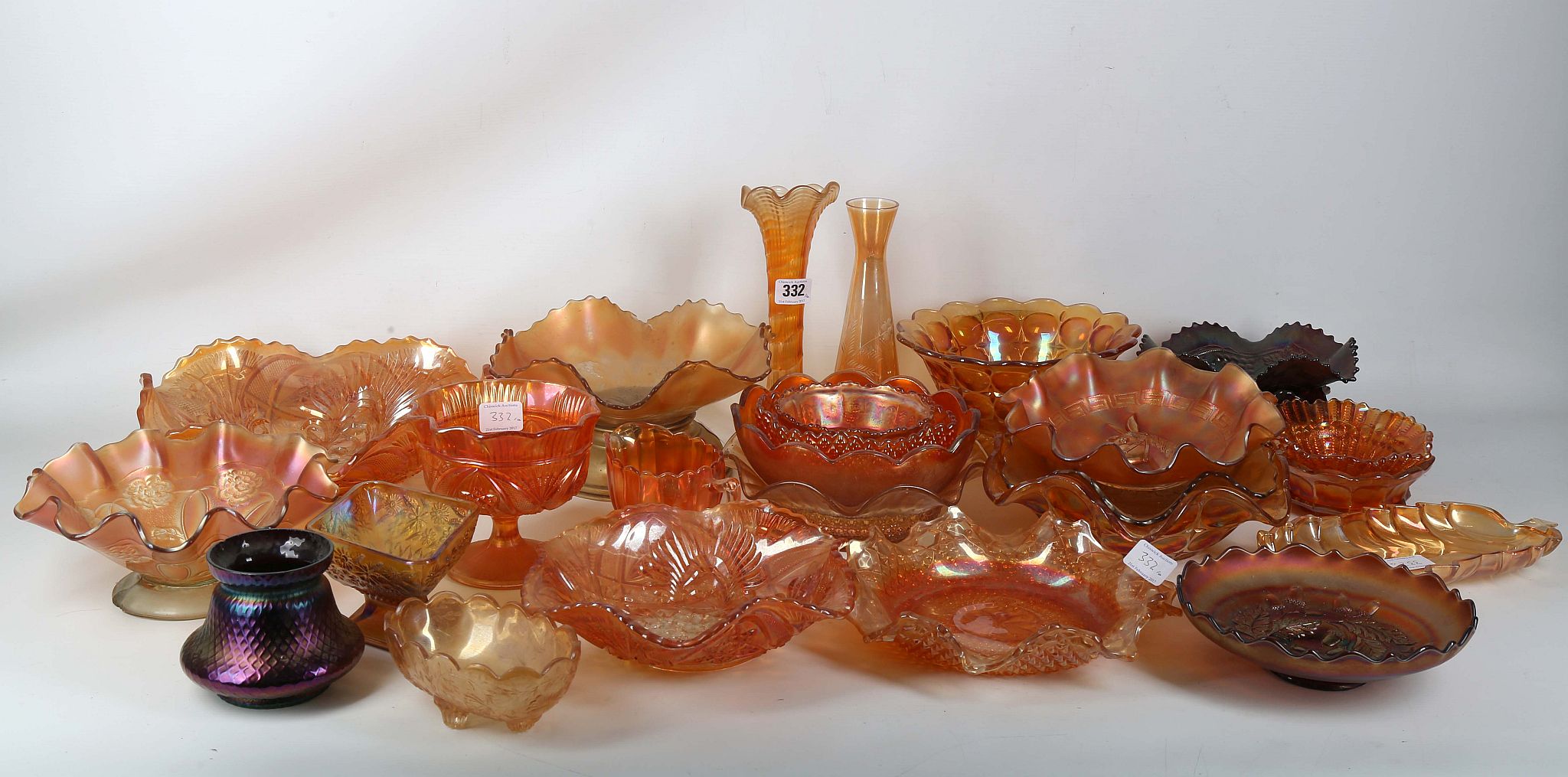 A large collection of moulded lustre Carnival glass, in shades of orange, comprising bowls, a leaf-