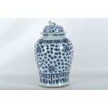 An 18th Century Chinese blue and white vase and cover, supported by four temple lion heads,