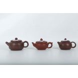 A small collection of three Chinese terracotta brown glazed teapots.